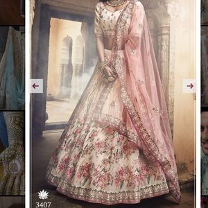 Beautiful cream color lengha with pink & green embroidery